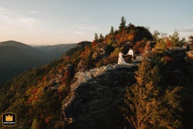 The couple walk along an iconic rock formation at The Chimneys, North Carolina, after their elopement ceremony